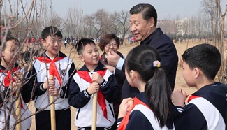 Xi attends tree planting activity, calls for understanding, protecting nature