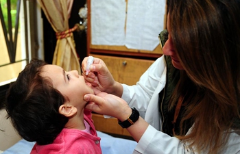 Children receive vaccine in Damascus, Syria